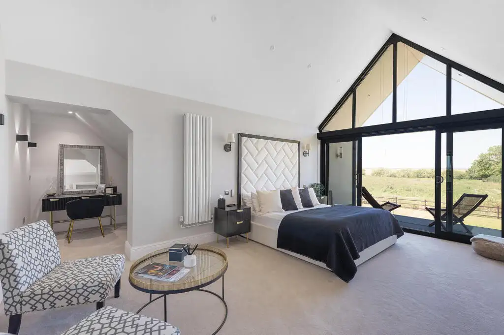 Main bedroom and full height glazed gable in the Graveley new build